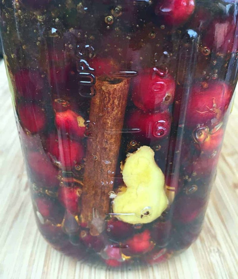 Glass canning jar with cranberries, cinnamen & ginger
